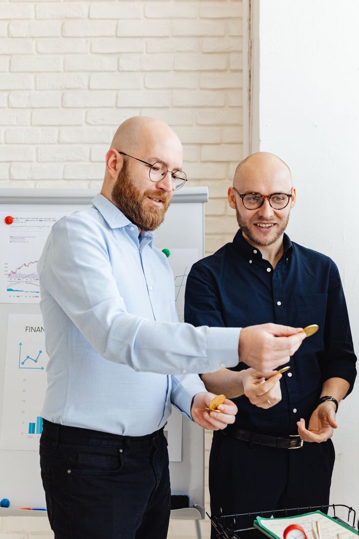 Services Two business professionals analyzing financial data in an office setting.